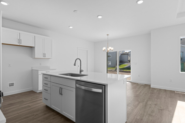 2823 North 710 West, Unit 16 Logan, UT 84321 - Photo 16 of 22 Kitchen with dark wood finished floors, dishwasher, hanging lights, a kitchen island with sink, and white cabinets