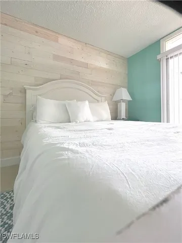 a large bed sitting in a bedroom next to a window