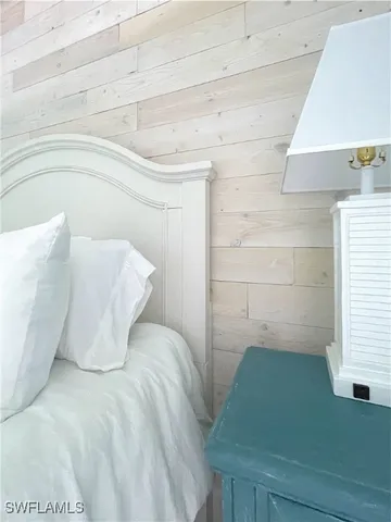 a spacious bedroom with a bed and a chandelier