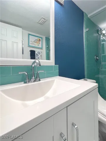 a picture of a bathroom with a sink and mirror