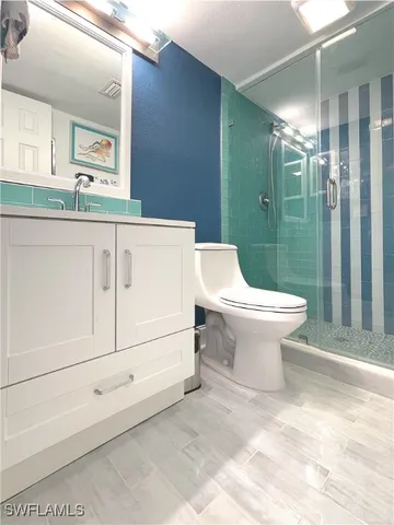 a bathroom with a toilet sink and shower