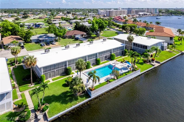 a view of swimming pool with outdoor seating and city view