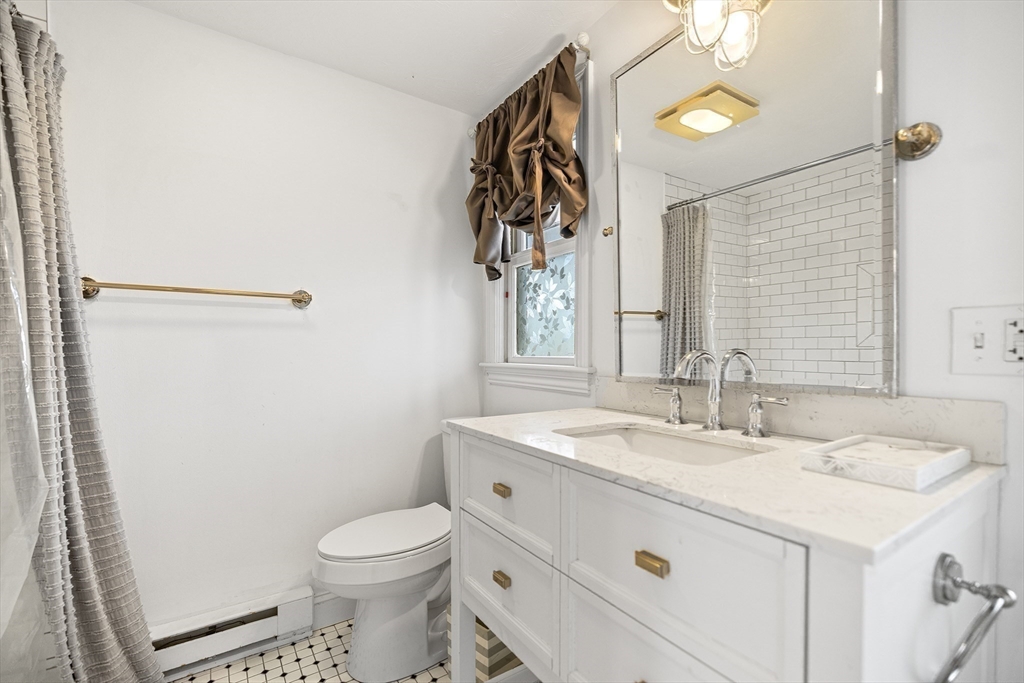 544 Shore Road, Unit 3 Truro, MA 02666 - Photo 27 of 30 a bathroom with a sink a toilet and mirror