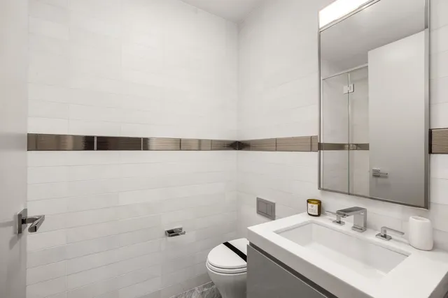a bathroom with a double vanity sink mirror and shower