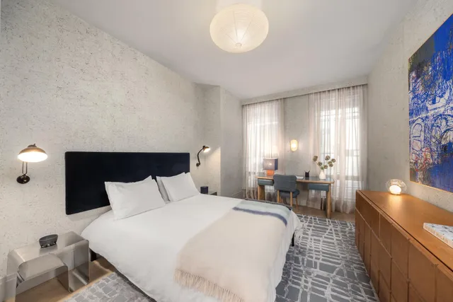 a bedroom with bed and window