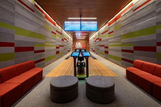 a reading room with furniture and a rug