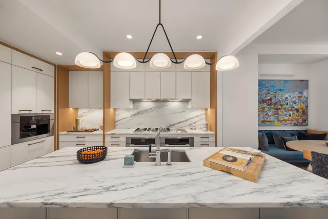 a hallway with a potted plant on the wooden floor
