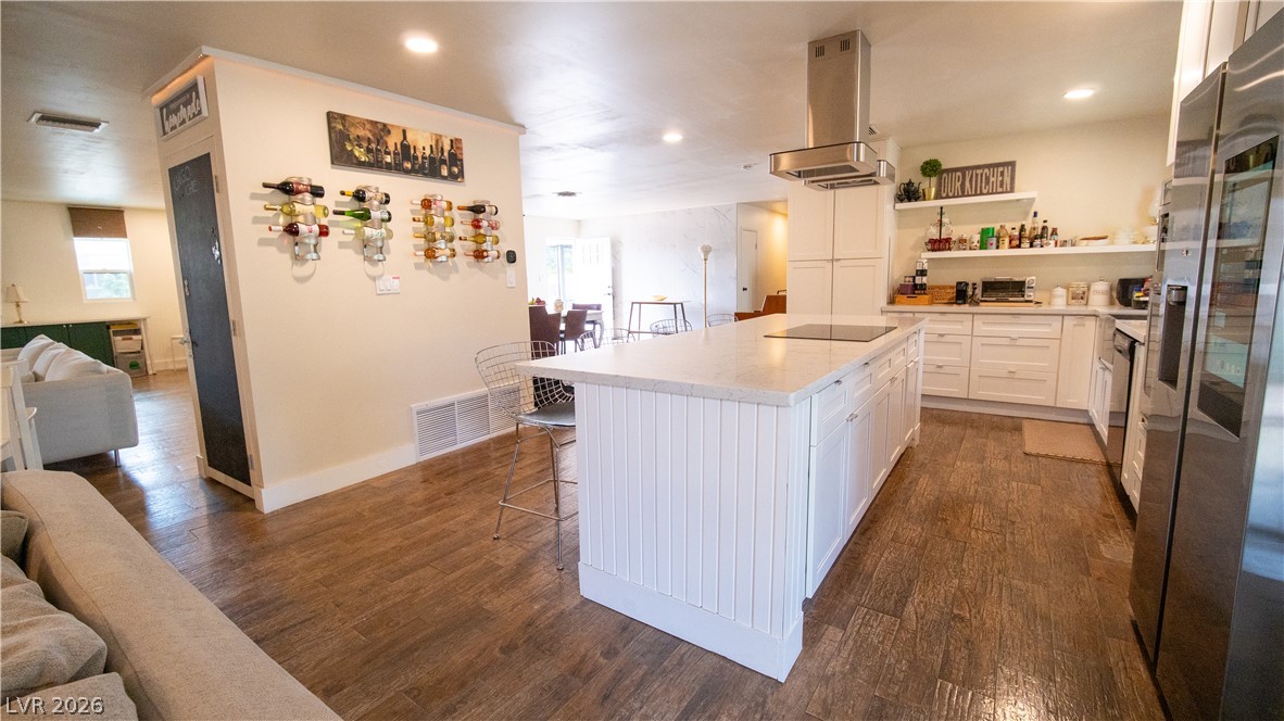 425 Blackridge Road Henderson, NV 89015 - Photo 31 of 31 An open floor plan connects the kitchen and living areas over rich wood-look flooring.
