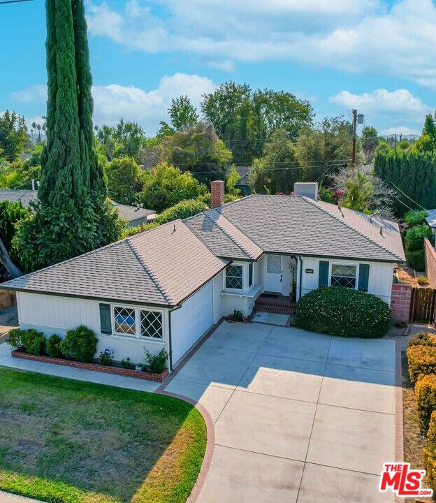 a aerial view of a house next to a yard