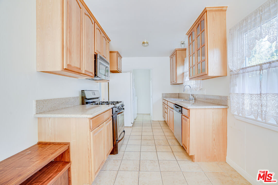 6919 Vanalden Avenue Reseda, CA 91335 - Photo 4 of 10 a kitchen with stainless steel appliances granite countertop a stove and a sink