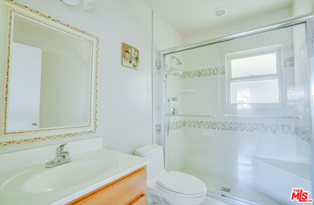 6919 Vanalden Avenue Reseda, CA 91335 - Photo 7 of 10 a bathroom with a sink a toilet and shower