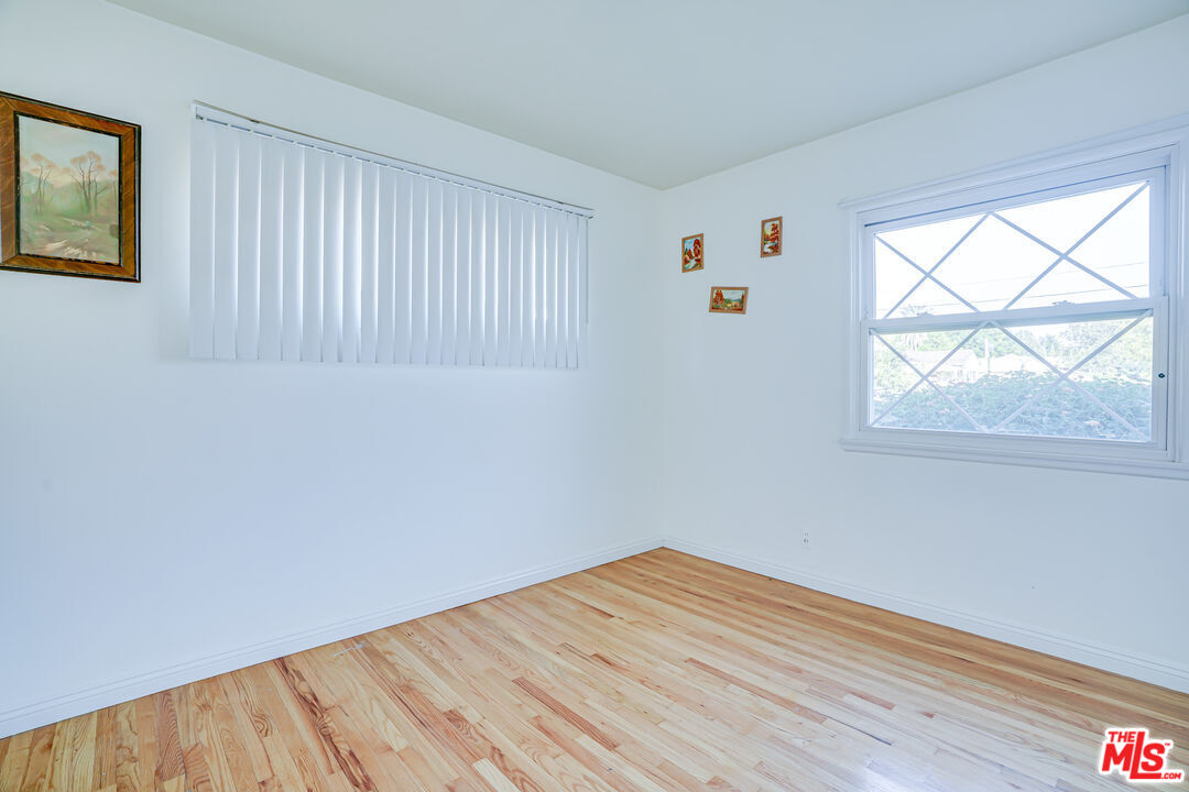 6919 Vanalden Avenue Reseda, CA 91335 - Photo 8 of 10 a view of empty room with wooden floor and fan