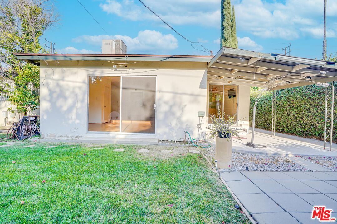 6919 Vanalden Avenue Reseda, CA 91335 - Photo 9 of 10 a front view of a house with garden