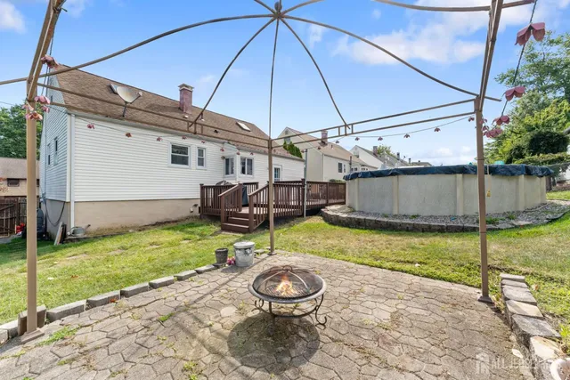 a view of a backyard with table and chairs under an umbrella