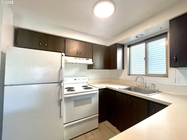 a kitchen with a sink a stove and refrigerator