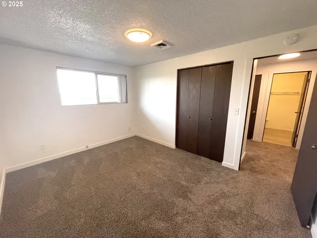 an empty room with closet area