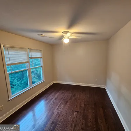 a white toilet sitting next to a bath tub
