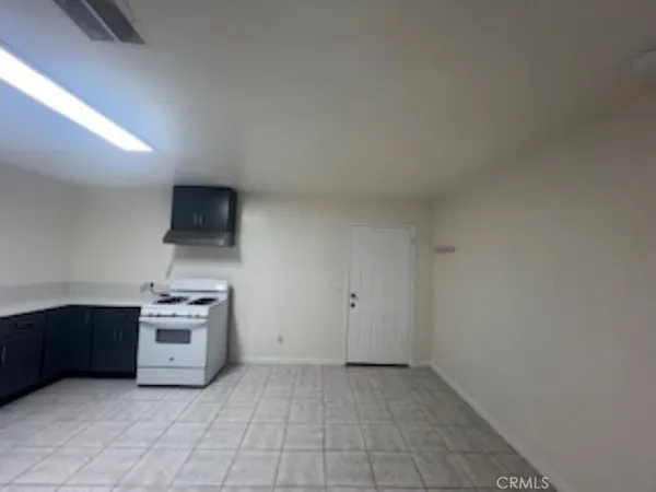 a kitchen with a stove top oven and cabinets