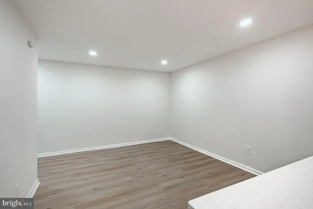a view of room with wooden floor and natural light