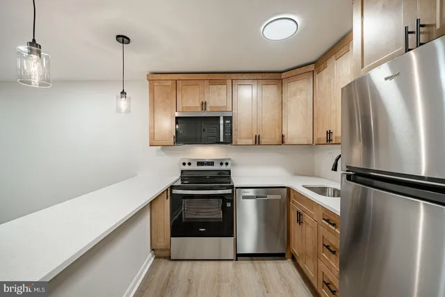 a kitchen with a sink appliances and cabinets