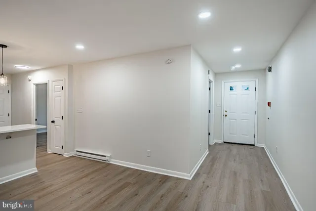 a view of a hallway with wooden floor