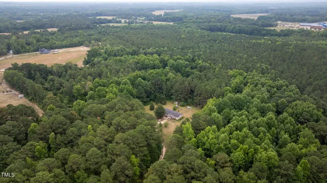 an aerial view of residential house with parking space and trees