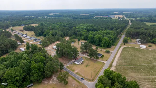 an aerial view of a house with a yard