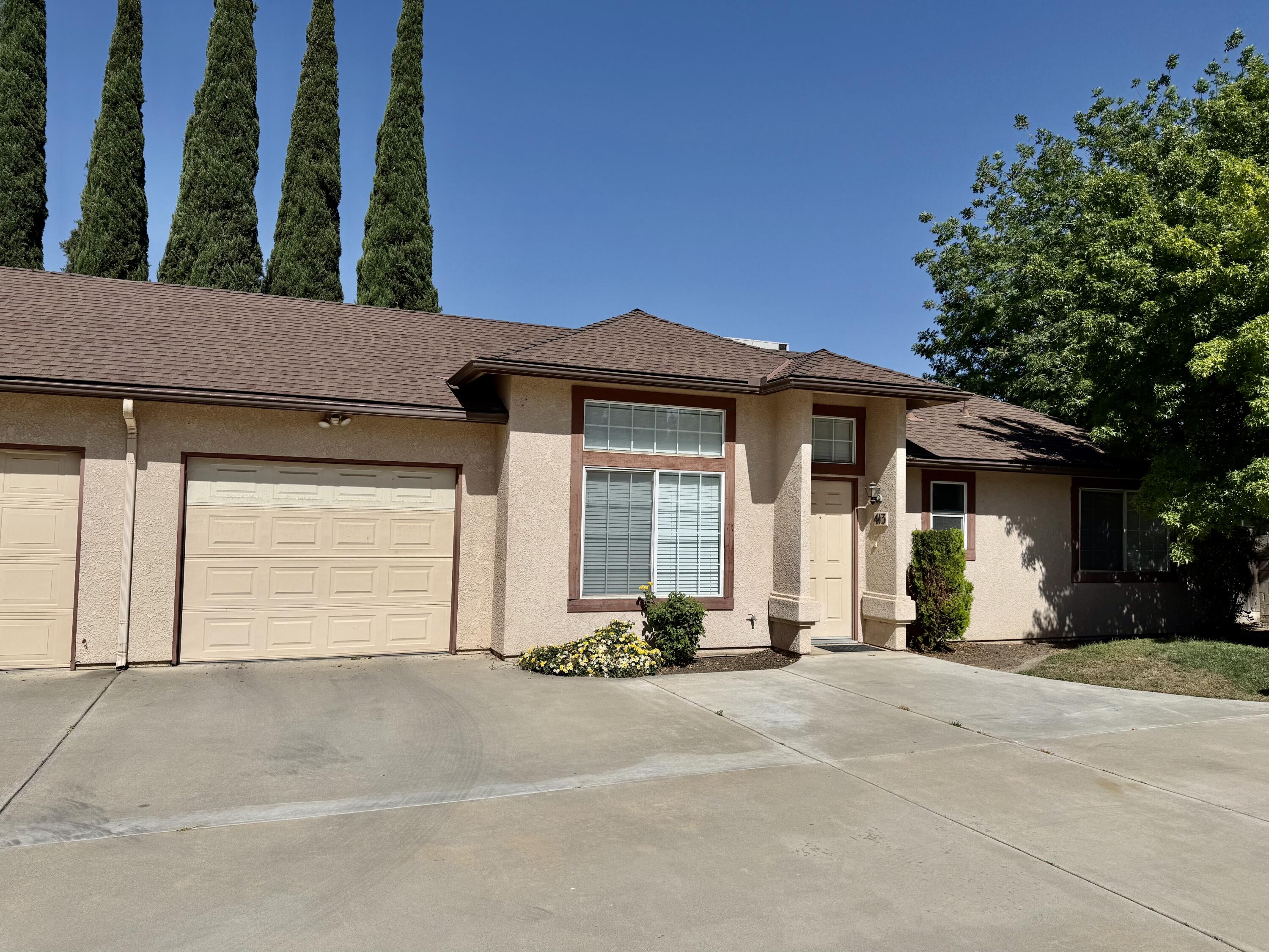 411 East Prospect Avenue Exeter, CA 93221 - Photo 2 of 4 a front view of a house with a garden