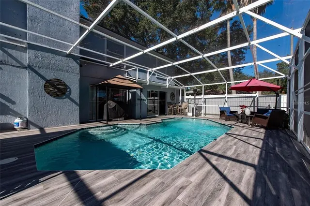 a view of a backyard with sitting area