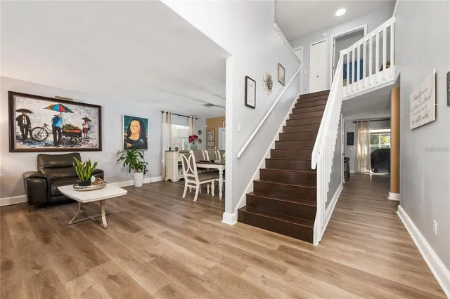 a view of entryway and hall with wooden floor