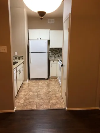 a view of room with window and wooden floor