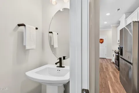 a bedroom with a bed and a lamp on the dresser