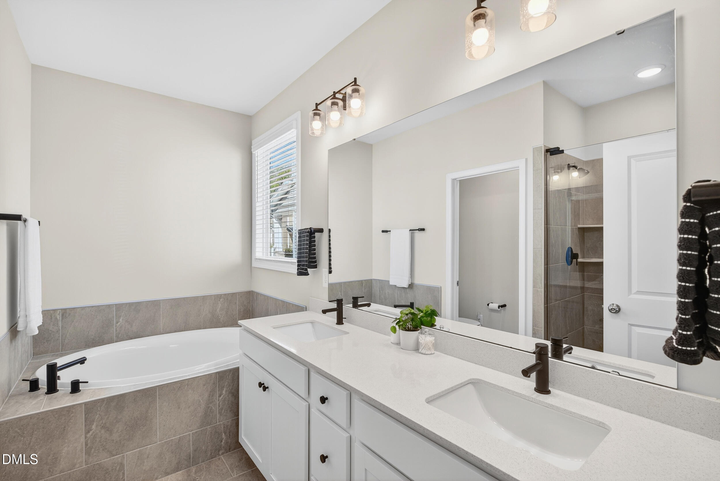 143 Umbrella Way Garner, NC 27529 - Photo 18 of 32 a bathroom with a sink double vanity granite tub shower and a mirror