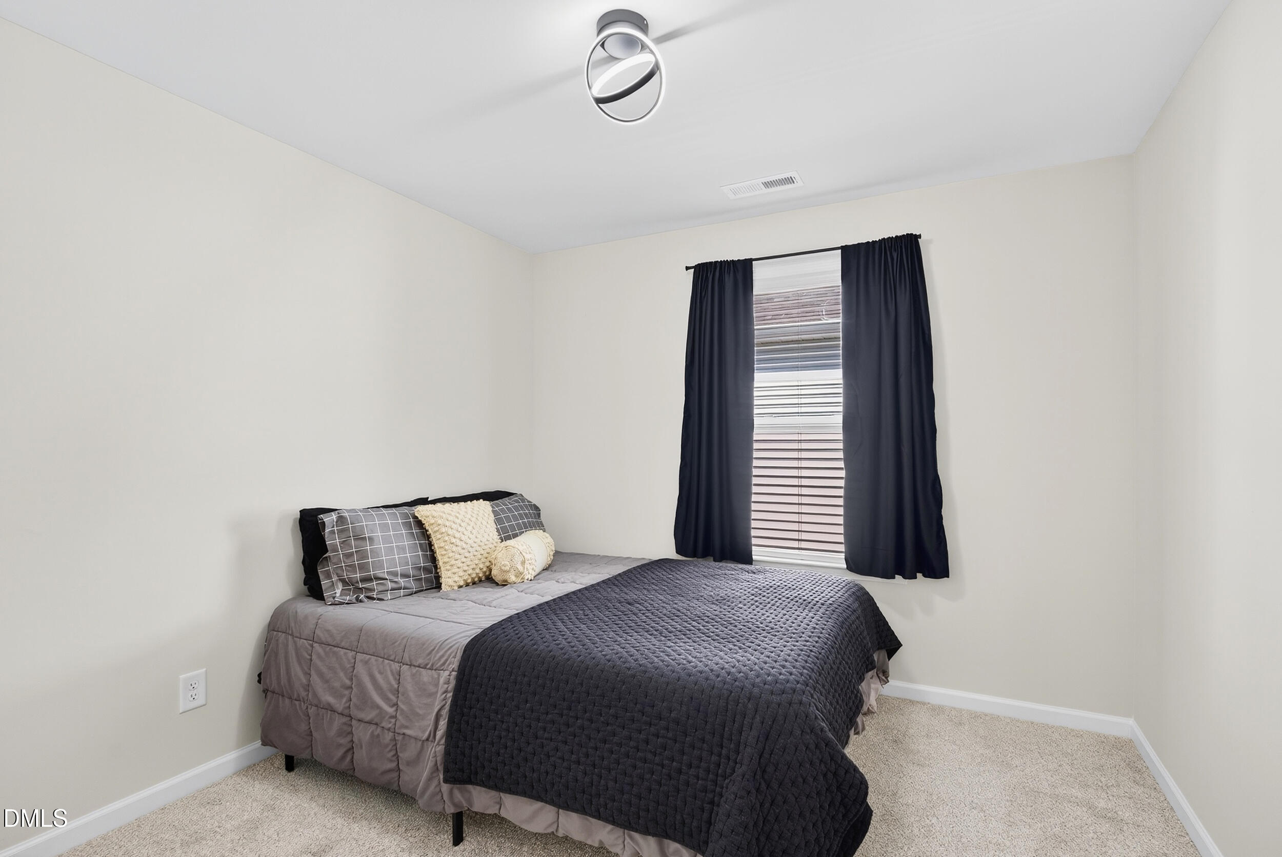 143 Umbrella Way Garner, NC 27529 - Photo 21 of 32 a bedroom with a bed and window