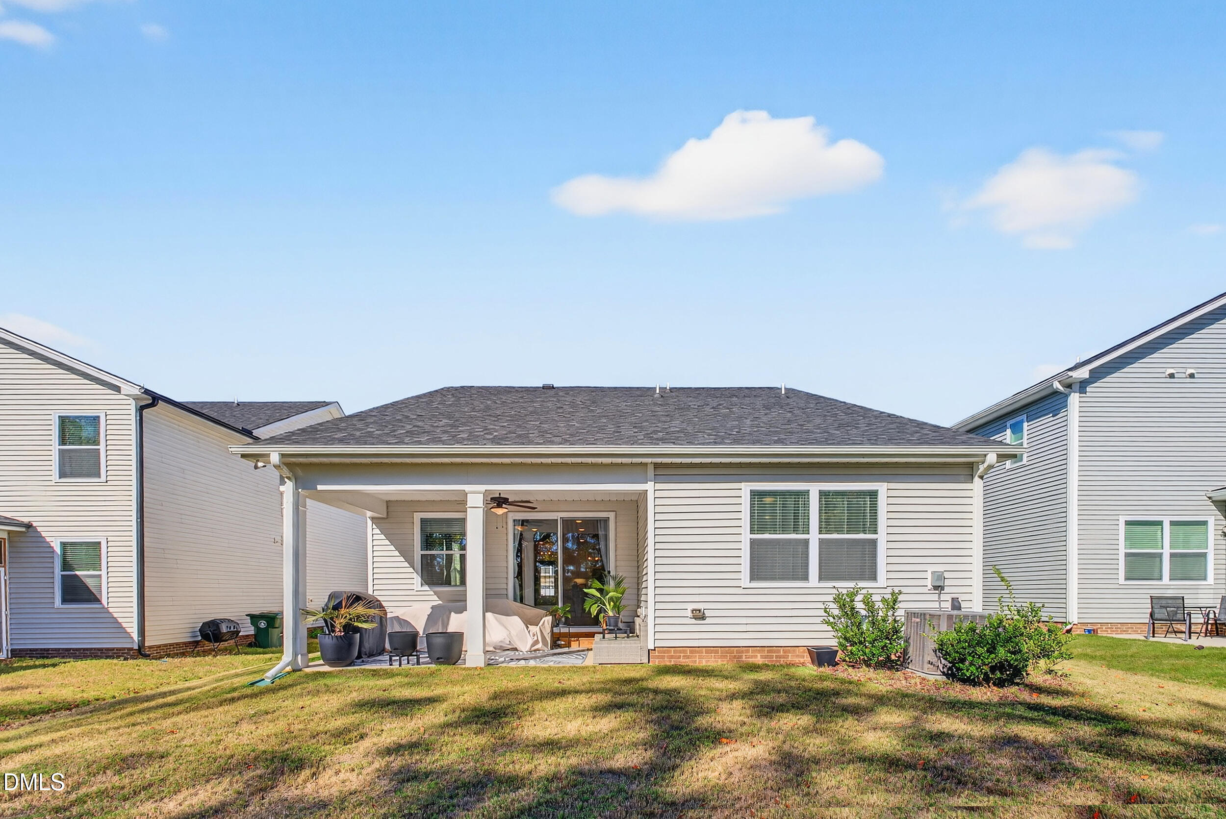 143 Umbrella Way Garner, NC 27529 - Photo 26 of 32 a front view of a house with a garden and patio