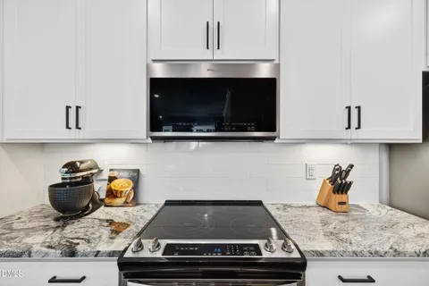 a view of kitchen with sink and refrigerator