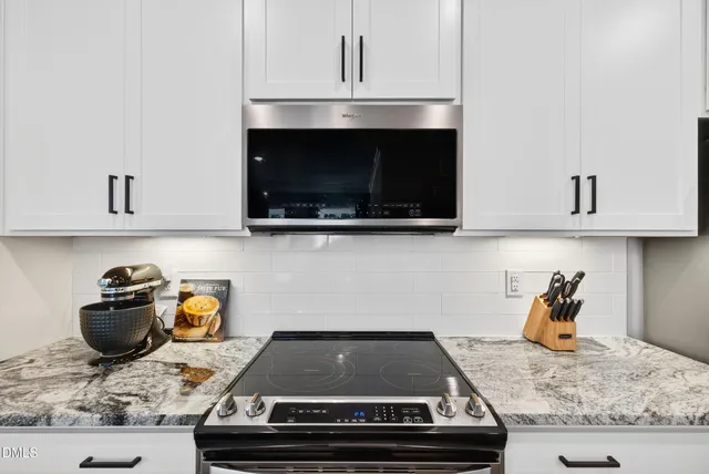 a view of kitchen with sink and refrigerator
