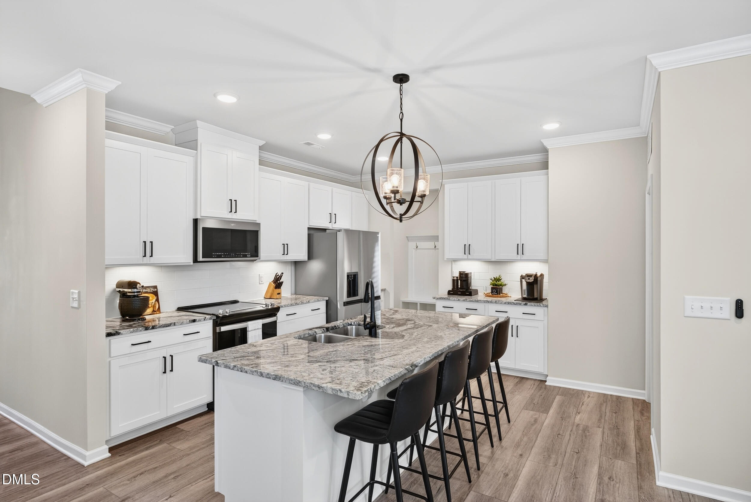 143 Umbrella Way Garner, NC 27529 - Photo 8 of 32 a kitchen with stainless steel appliances granite countertop a stove a sink dishwasher a microwave oven with a dining table and chairs