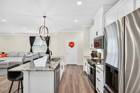 a kitchen with a sink and a granite top table