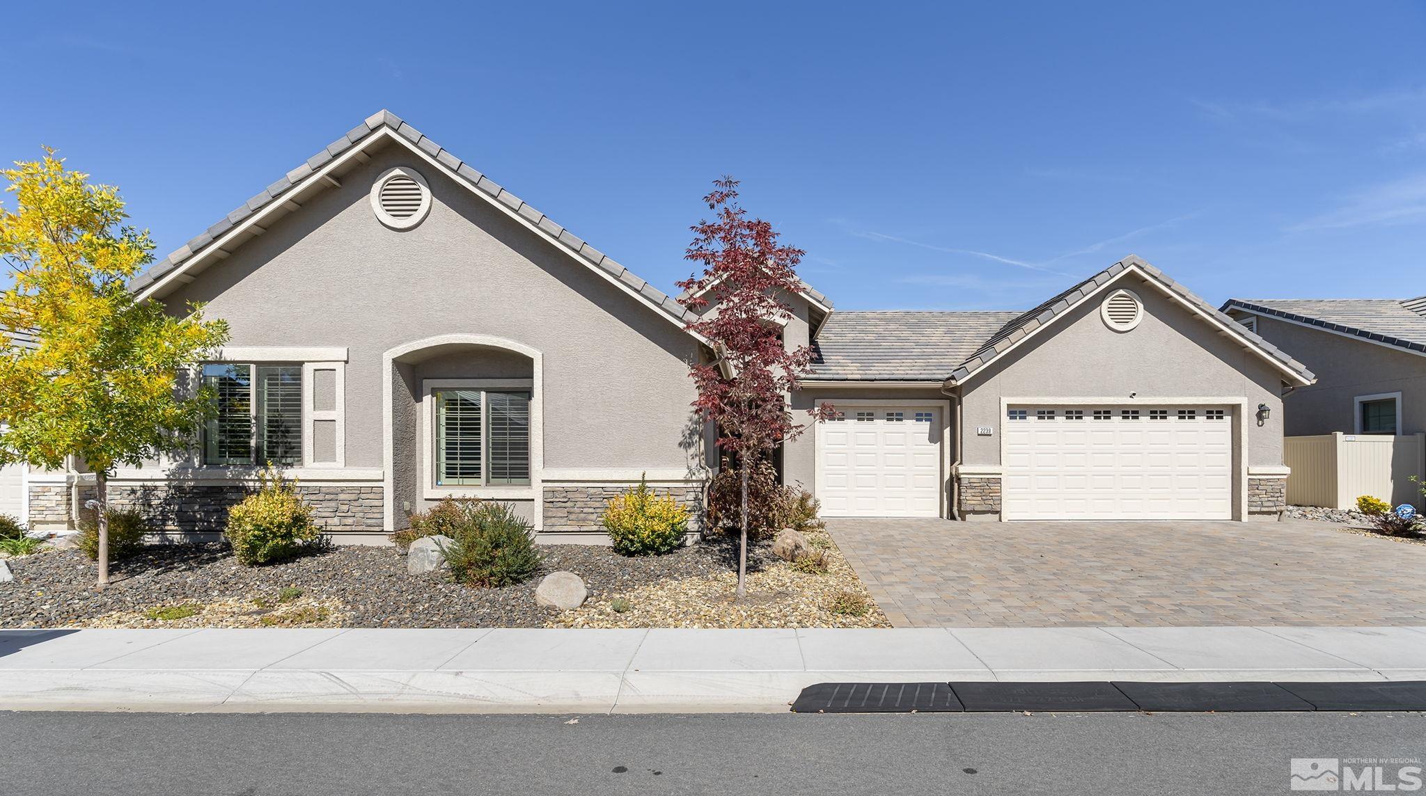2239 Windflower Drive Reno, NV 89521 - Photo 2 of 40 a front view of a house with a yard