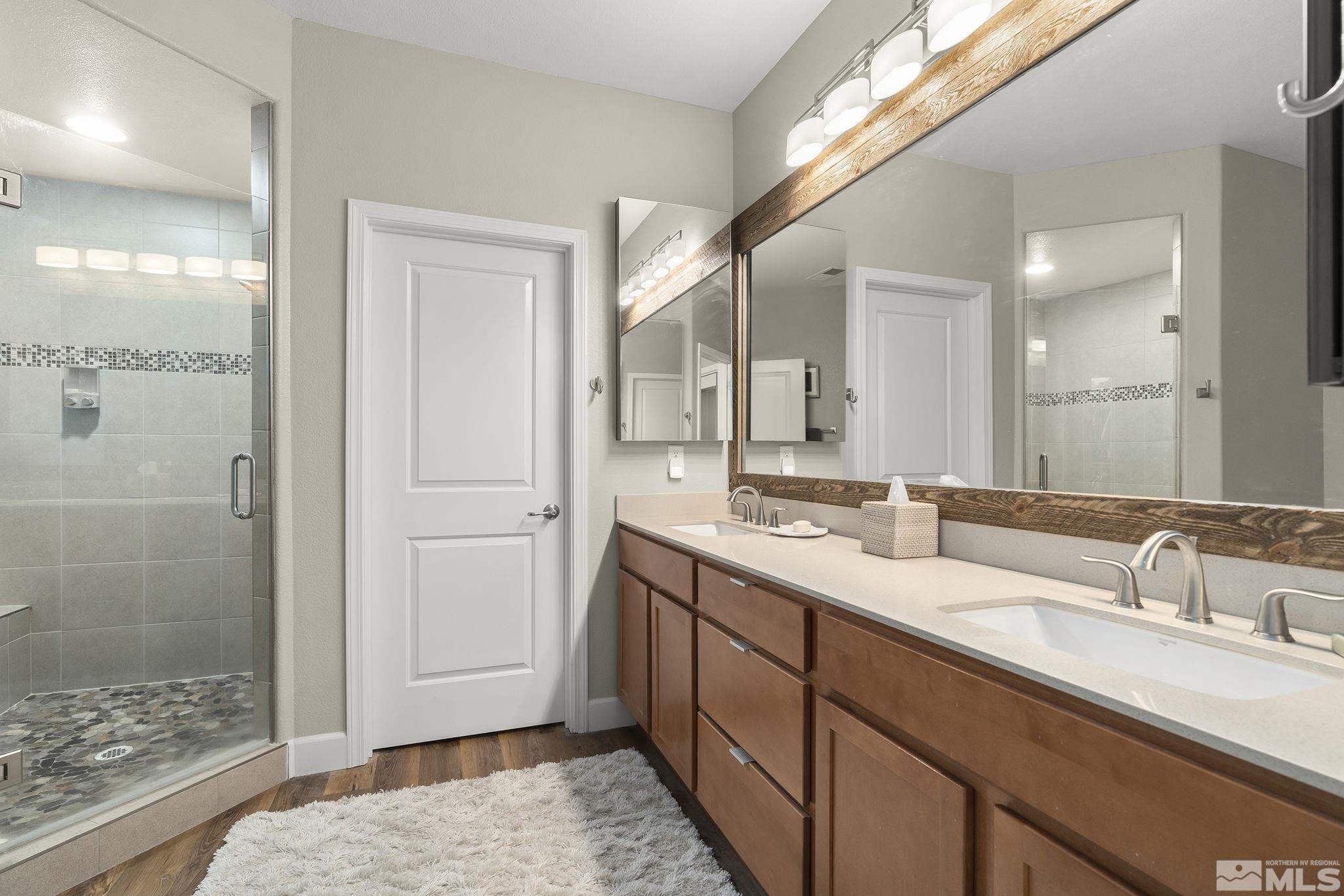 2239 Windflower Drive Reno, NV 89521 - Photo 21 of 40 a spacious bathroom with double sink and a mirror