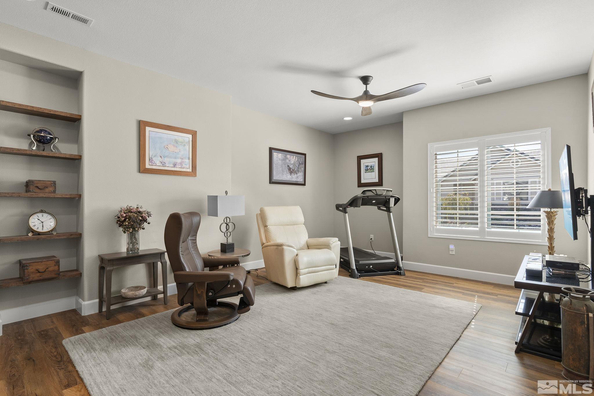 2239 Windflower Drive Reno, NV 89521 - Photo 23 of 40 a living room with furniture a window and gym equipment