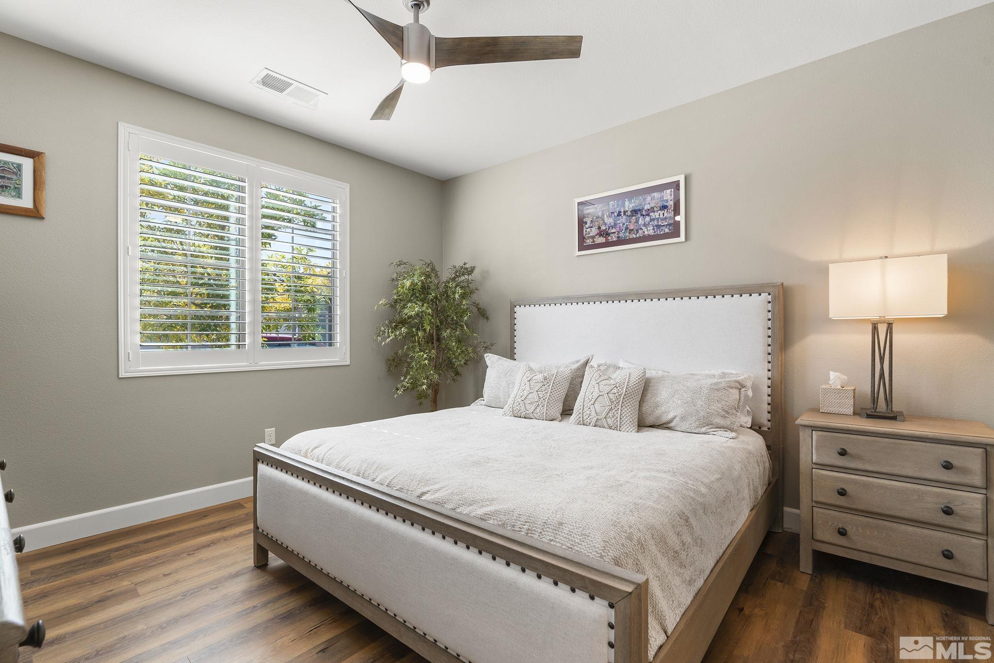 2239 Windflower Drive Reno, NV 89521 - Photo 25 of 40 a bedroom with a bed and a night stand