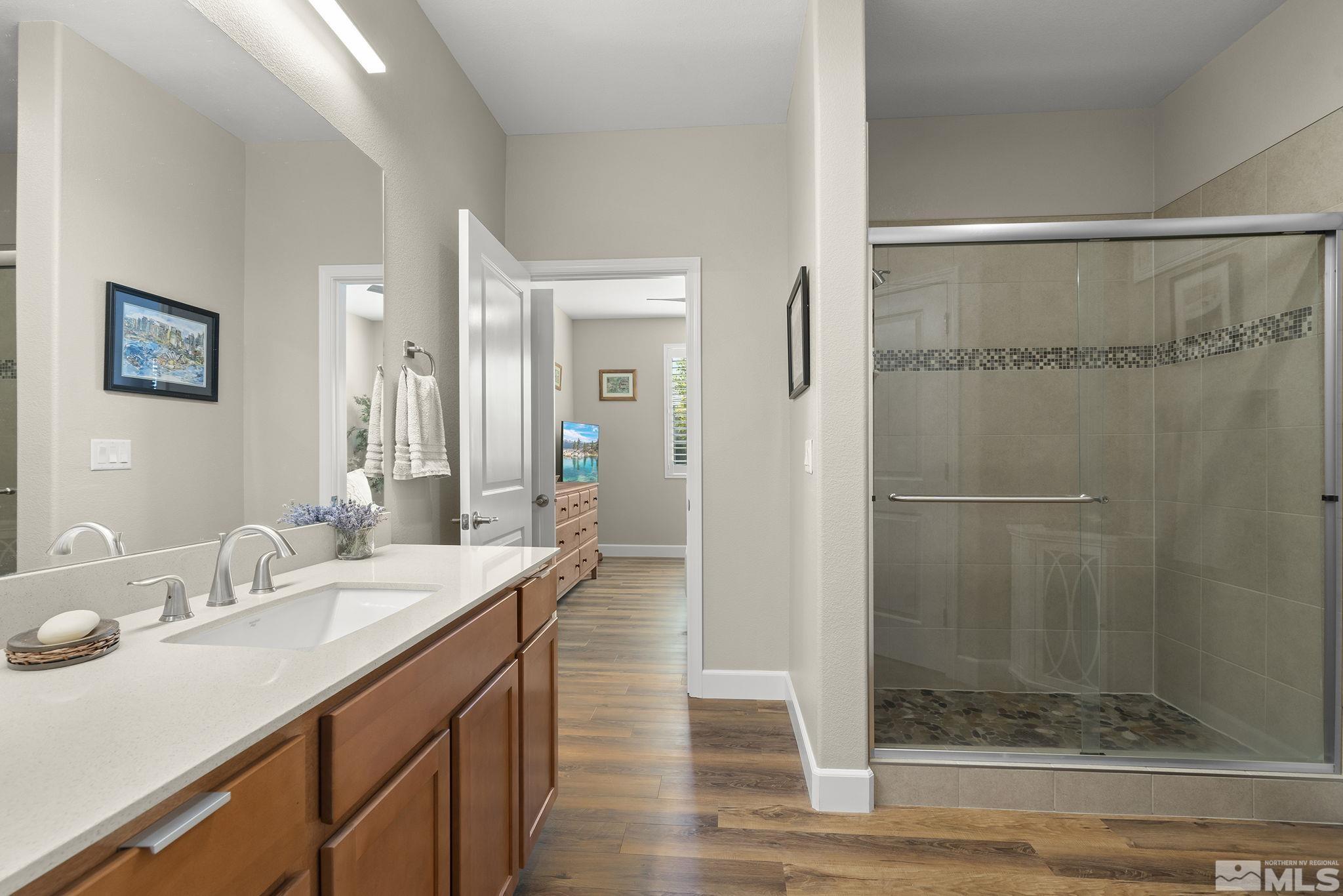 2239 Windflower Drive Reno, NV 89521 - Photo 26 of 40 a bathroom with a shower sink and mirror