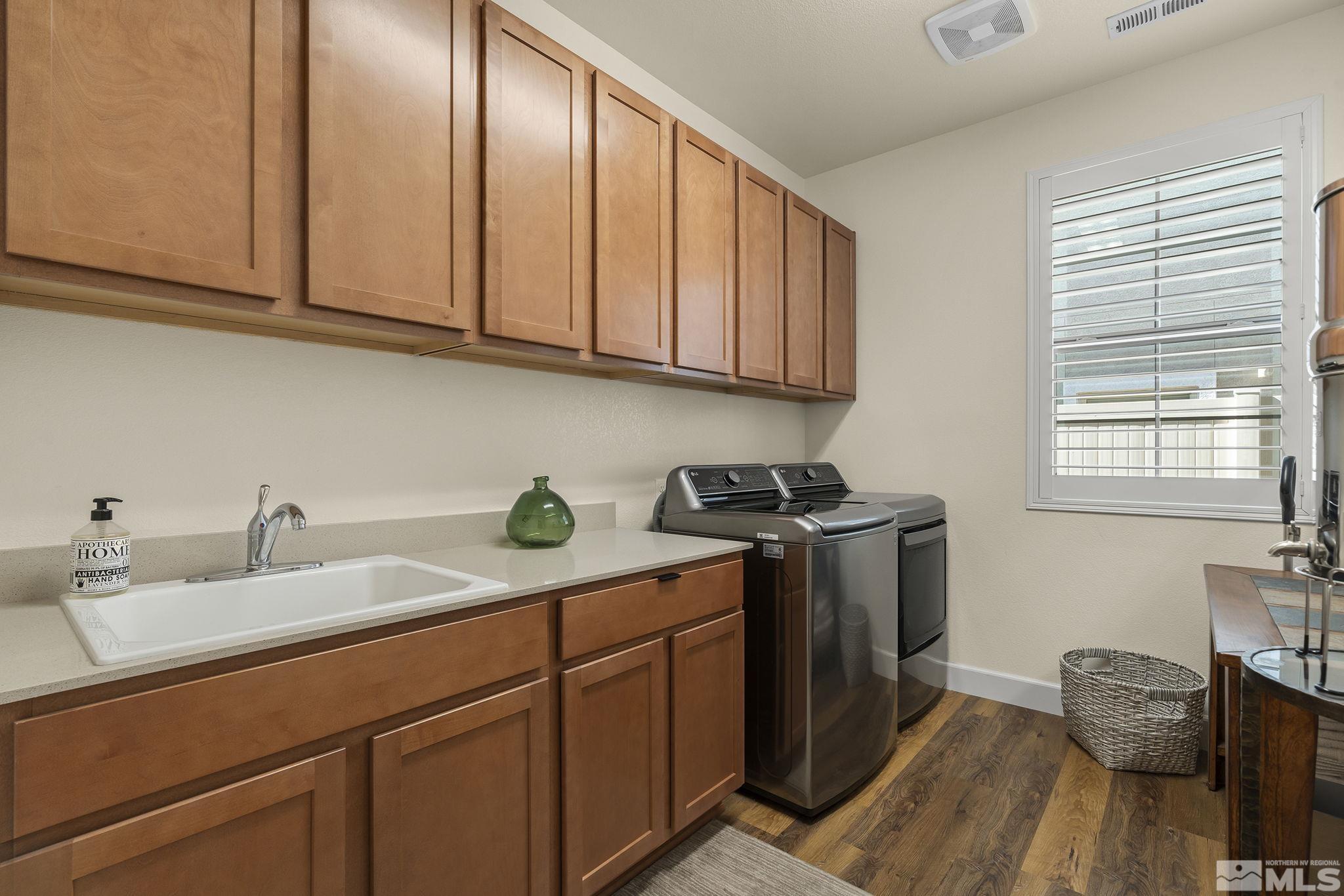 2239 Windflower Drive Reno, NV 89521 - Photo 27 of 40 a kitchen with stainless steel appliances granite countertop a sink a stove cabinets and wooden floor