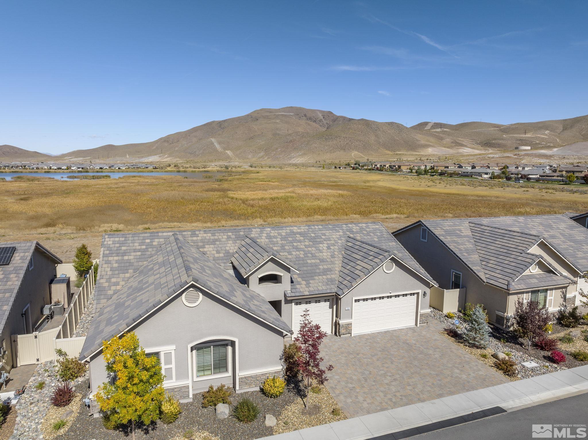 2239 Windflower Drive Reno, NV 89521 - Photo 4 of 40 a view of a house with a lake view