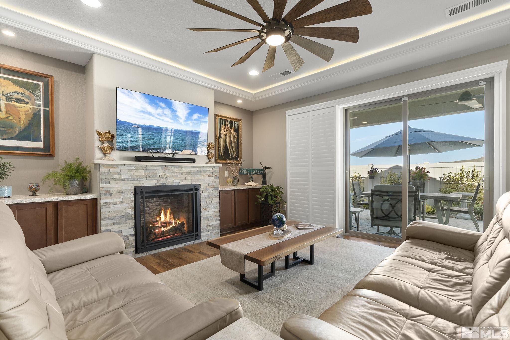 2239 Windflower Drive Reno, NV 89521 - Photo 6 of 40 a living room with furniture a flat screen tv and a fireplace