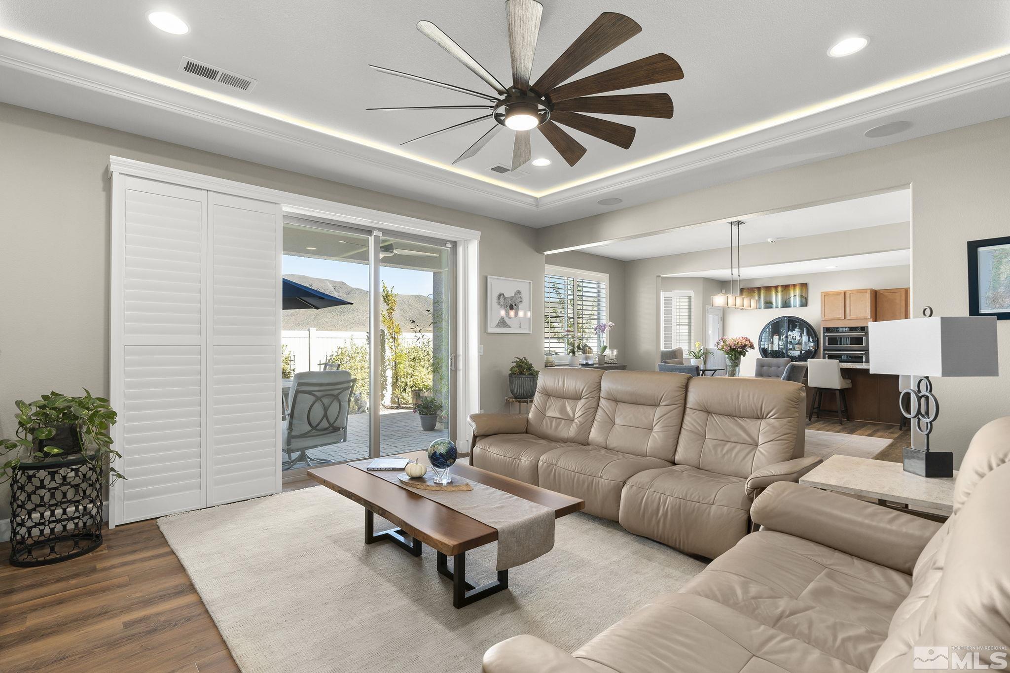 2239 Windflower Drive Reno, NV 89521 - Photo 7 of 40 a living room with furniture ceiling fan and a window