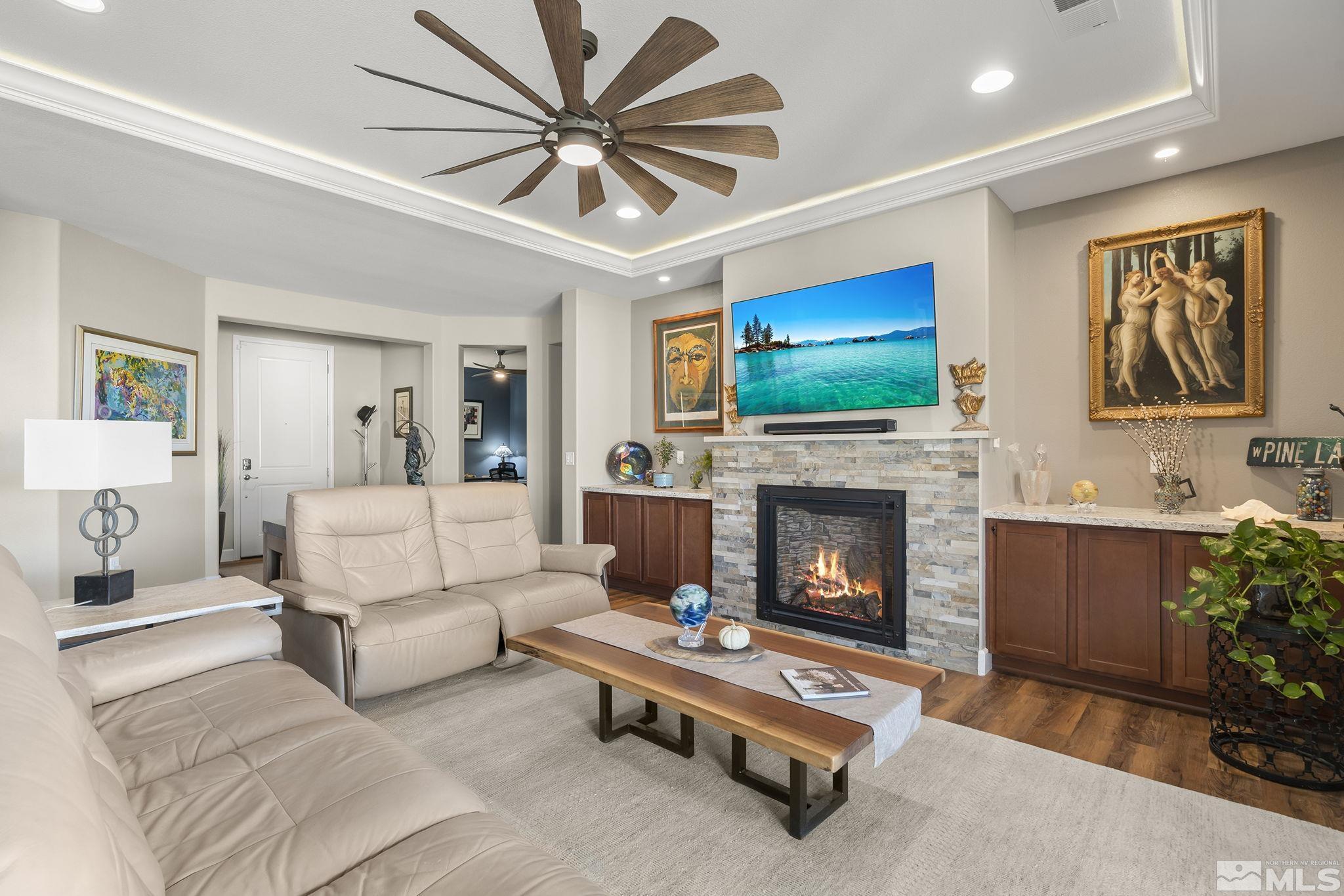 2239 Windflower Drive Reno, NV 89521 - Photo 9 of 40 a living room with furniture a flat screen tv and a fireplace