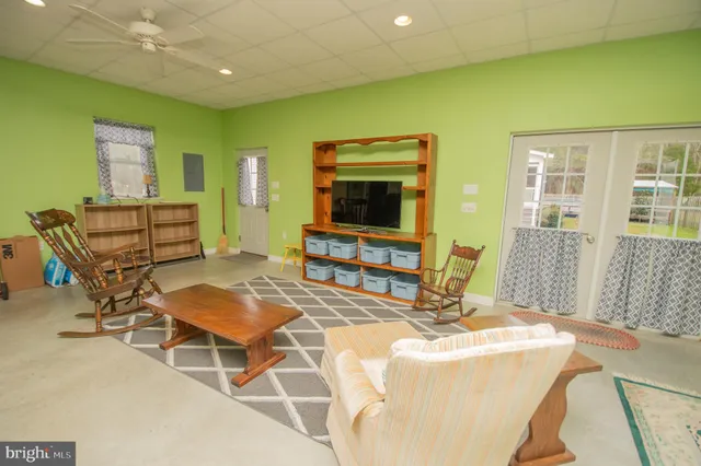 a dining room with furniture and a flat screen tv